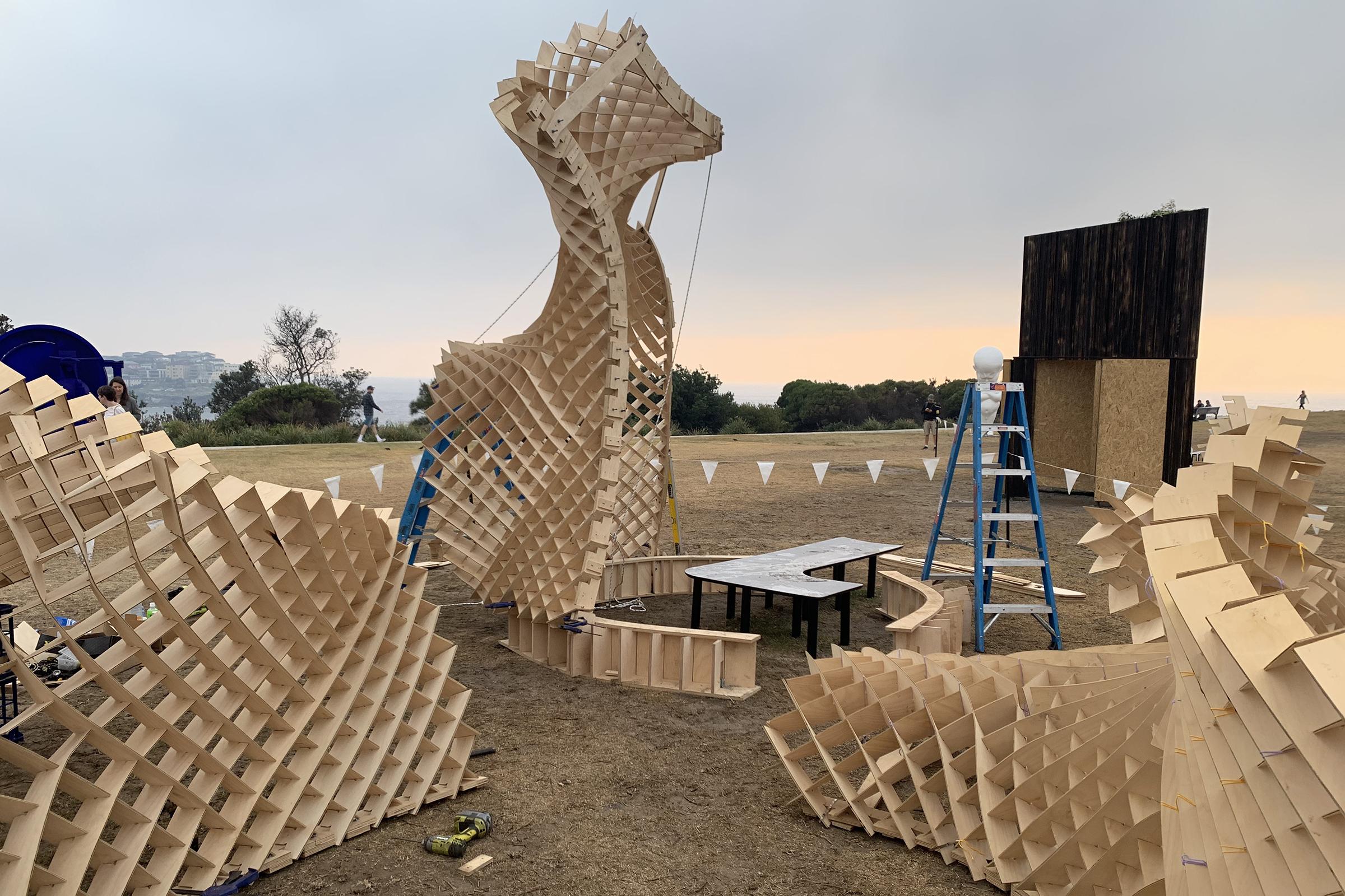 a wooden structure outside with a ladder and a table
