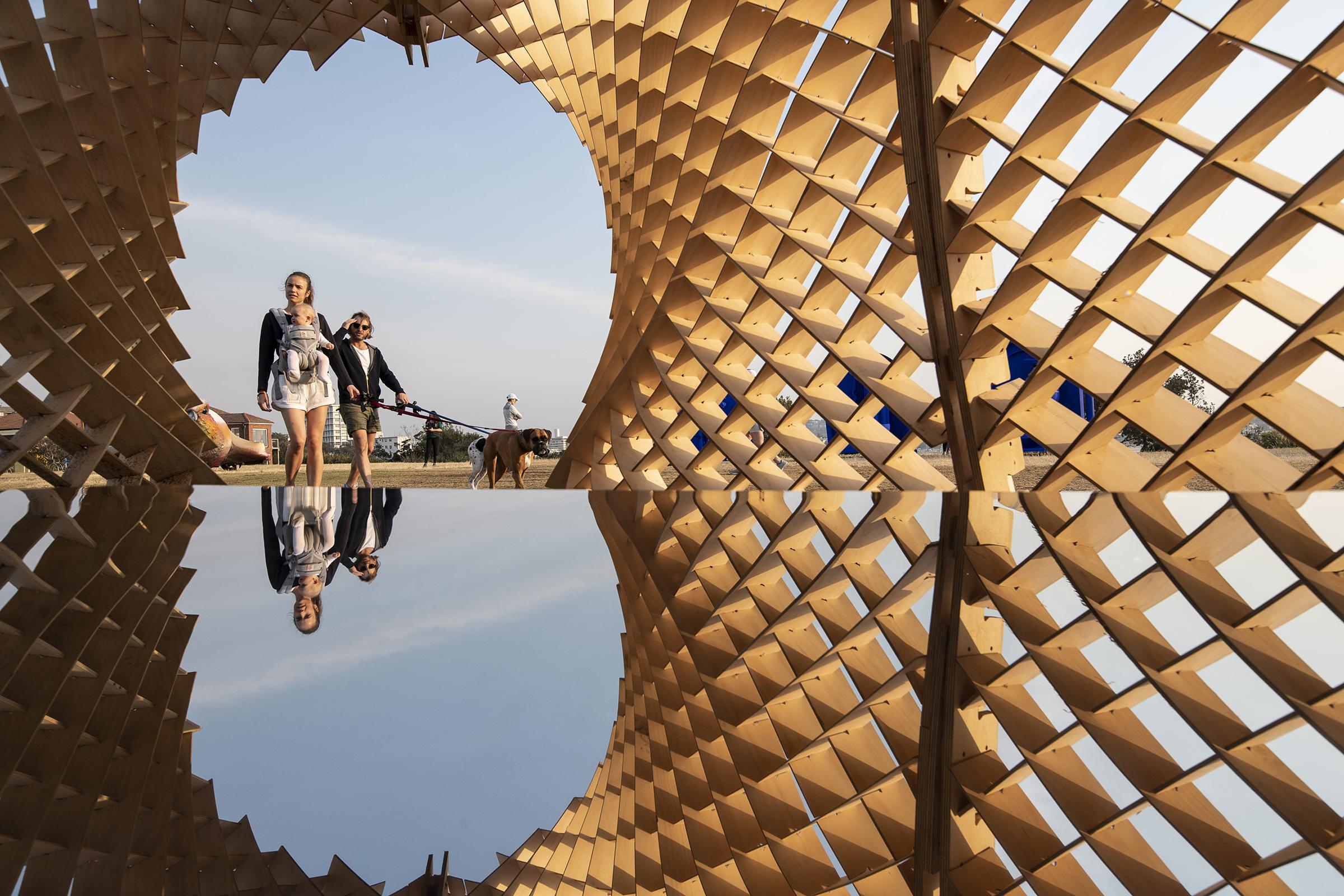 a woman and a dog walking in a tunnel