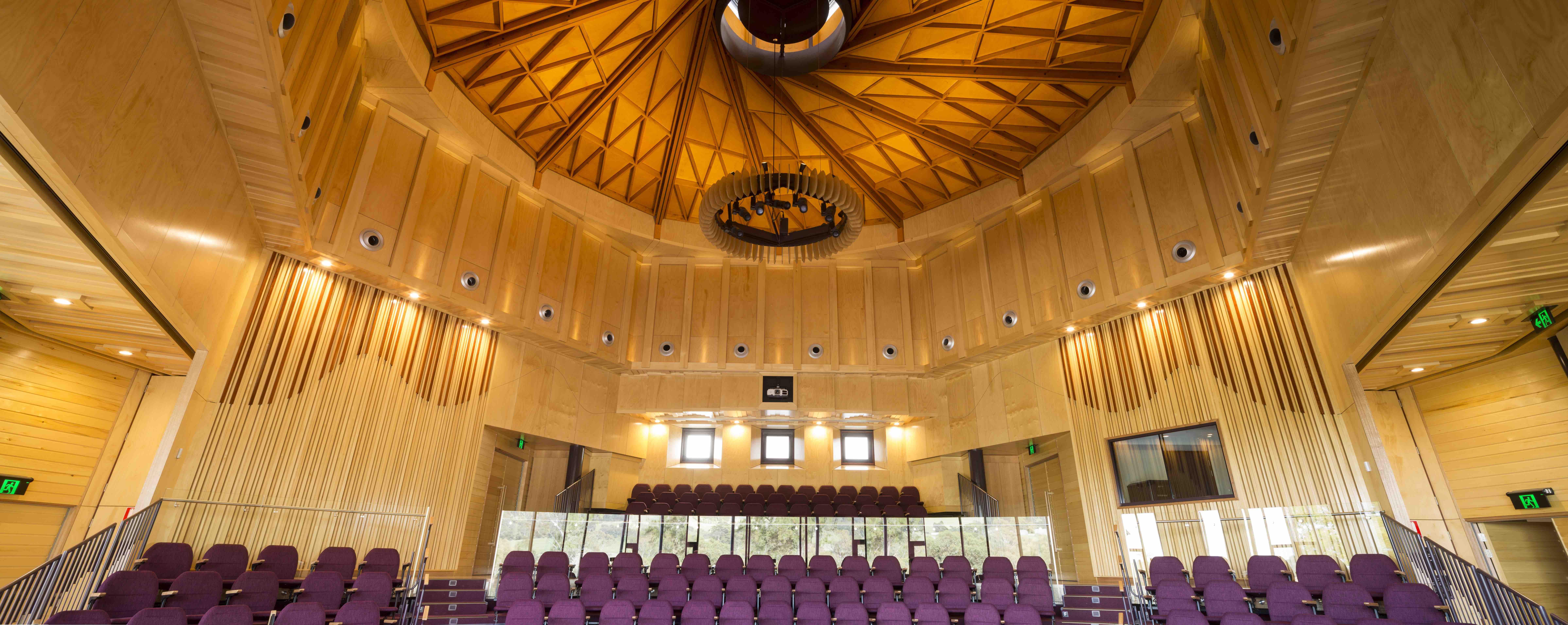 a room with purple chairs and a glass railing