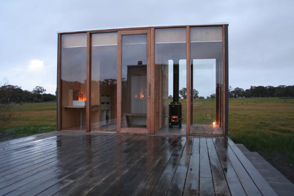 a glass building with a wood deck