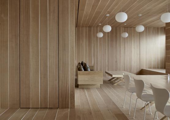 a room with wood paneling and white lamps
