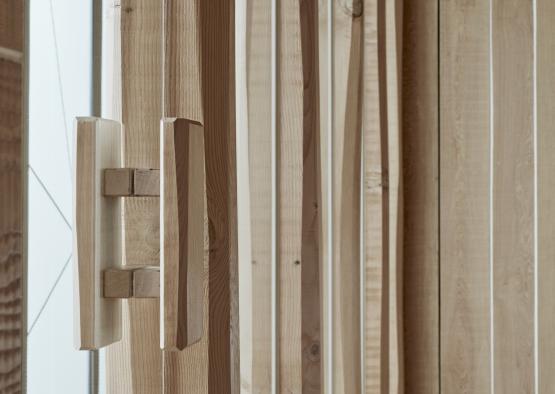 a wooden door hinge in a room