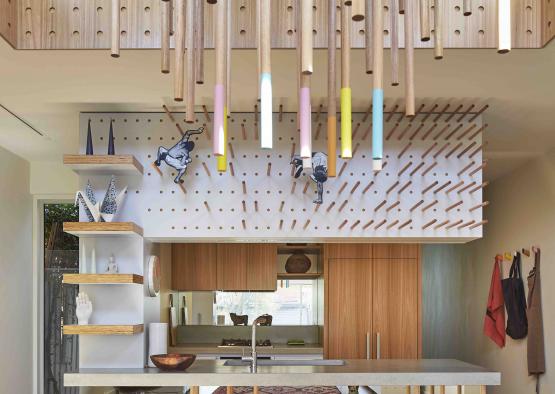a room with a kitchen and a large table