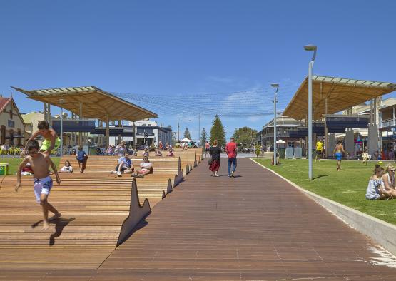 people sitting on a wooden walkway