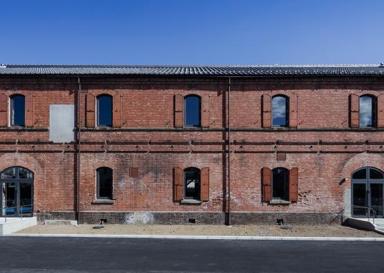 a brick building with windows with First Missouri State Capitol State Historic Site in the background