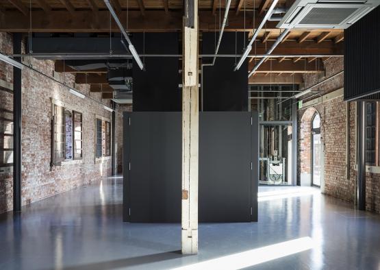 a room with brick walls and a large door