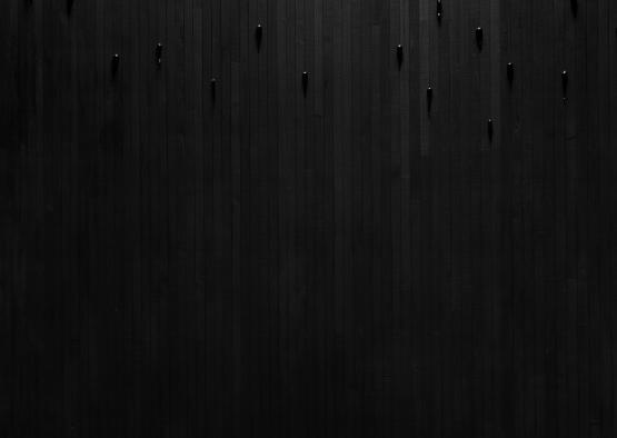 a black wall with a shelf