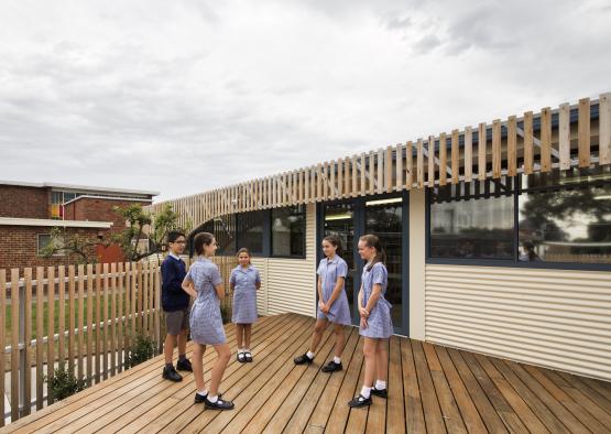 a group of children standing on a deck