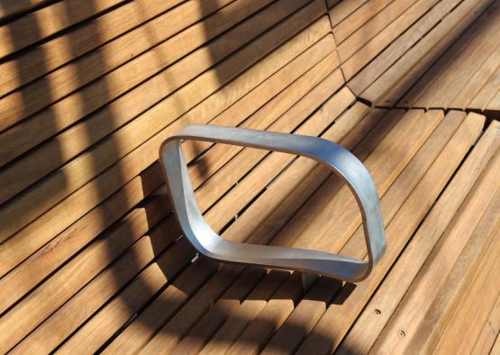 a metal object on a wood bench