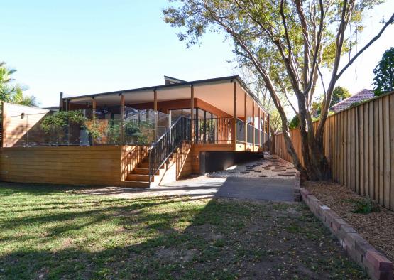 a house with a fence and grass