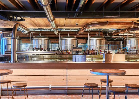 a bar with a counter and a few metal tanks