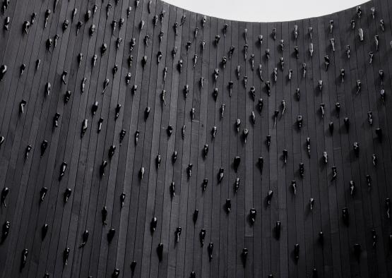 a wall with many black objects