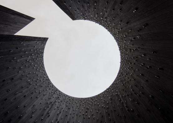 a looking up at a circular hole in a building