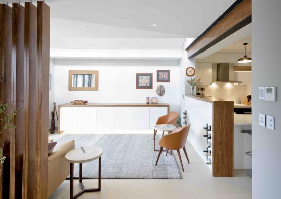 a room with a kitchen and dining area