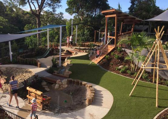 a playground with a slide and a sand pit
