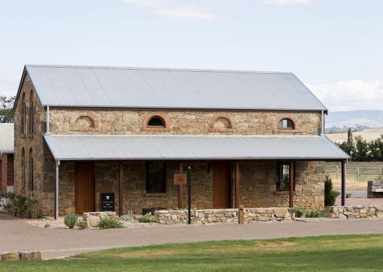 a stone building with a metal roof