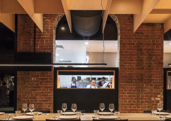 a table with wine glasses and a brick wall