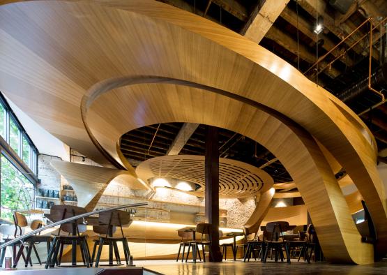 a room with a curved ceiling and chairs