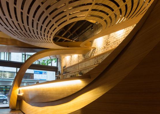 a curved wooden wall with a curved ceiling