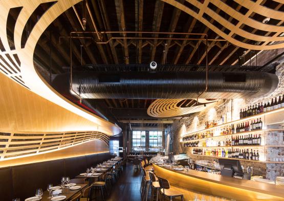 a restaurant with a bar and shelves of wine bottles