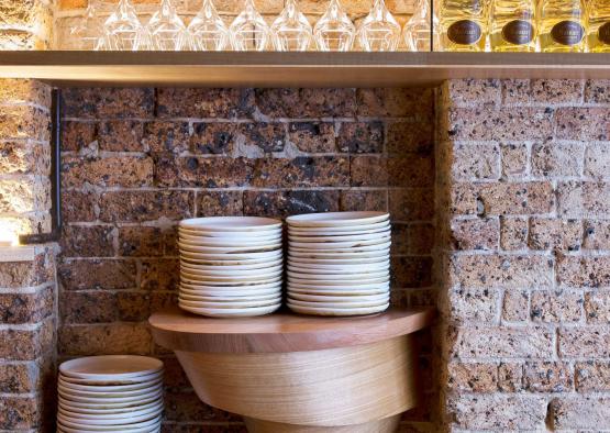 a stack of plates and glasses on a shelf