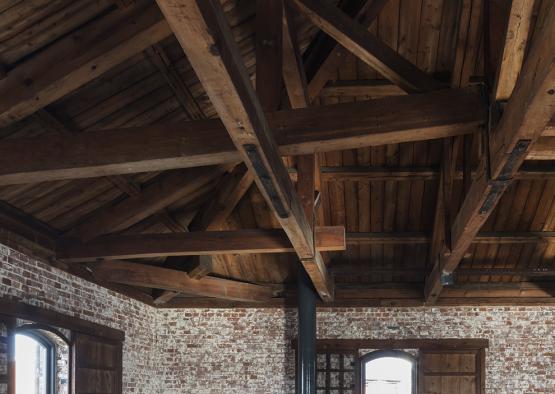 a room with brick walls and wooden beams