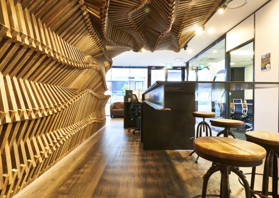 a wooden bar with stools and a counter