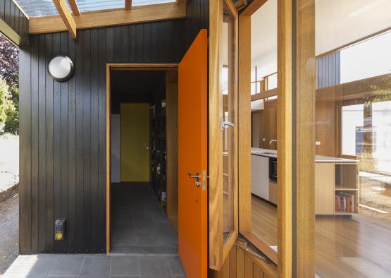 an orange door open to a room
