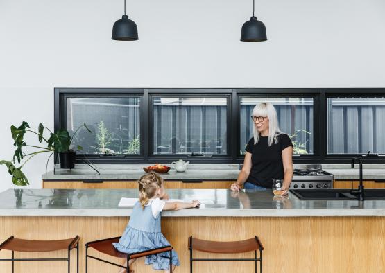 a woman and a girl in a kitchen