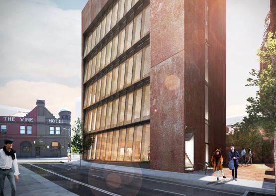 a building with windows and people standing on the sidewalk