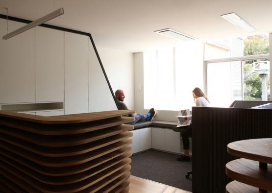 a man sitting on a bench in a room with a woman