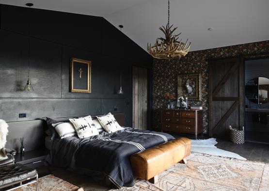 a bedroom with a bed and a chandelier