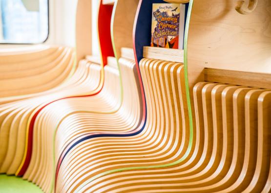 a row of wooden chairs with colorful stripes