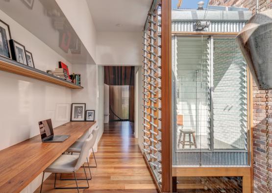 a room with a desk and a wood floor