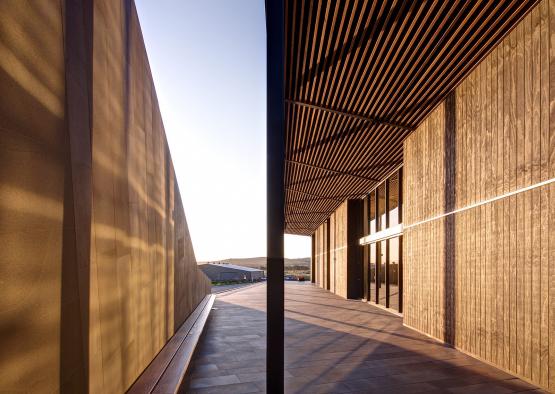 a building with a wooden wall and a wooden pillar