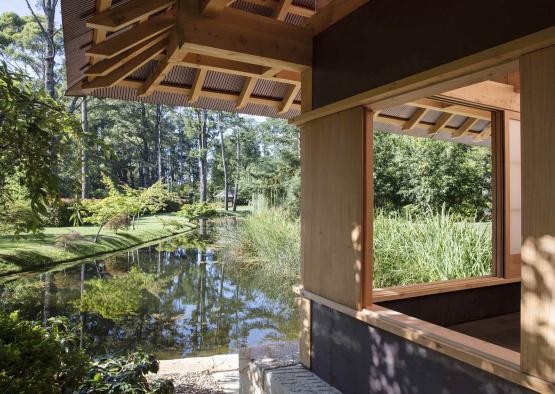 a building with a pond and trees