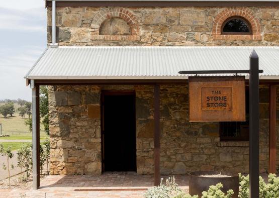 a stone building with a sign