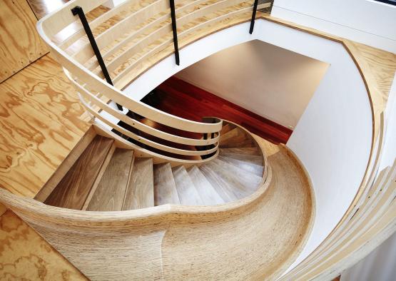 a spiral staircase with wooden railings