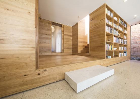 a room with a bookcase and stairs
