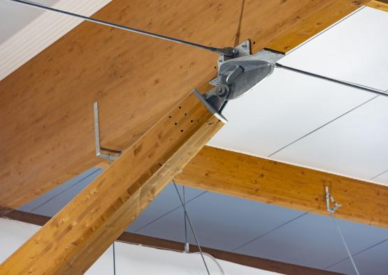 a metal beam attached to a wooden ceiling