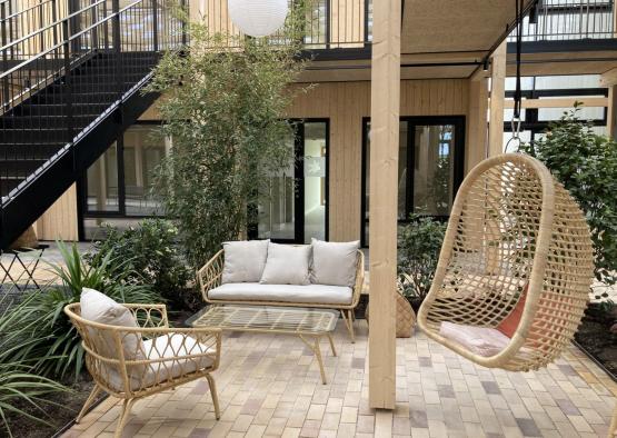 a patio with chairs and a table