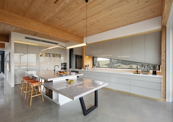 a kitchen with a large island and stools