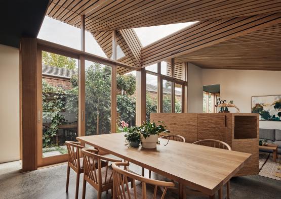 a dining table with chairs and a large skylight
