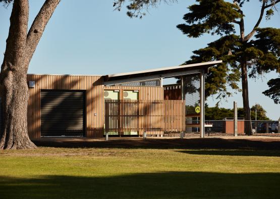 a building with a roof and a tree