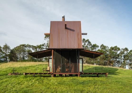 a small house on a grassy hill