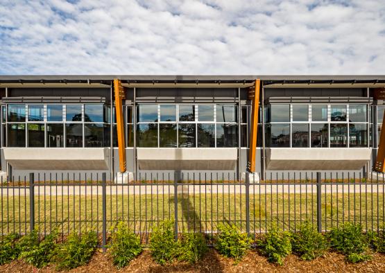 a building with a fence and grass