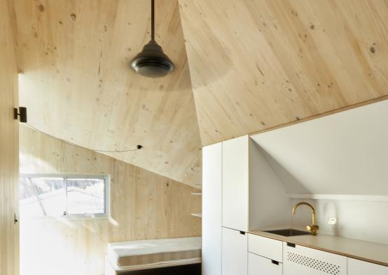 a room with a wood ceiling and a sink