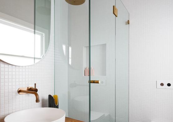 a bathroom with a glass shower and sink