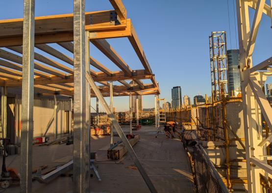 a construction site with a man standing on a roof