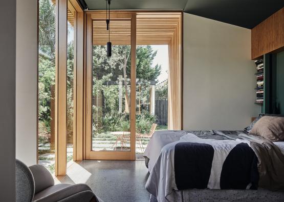 a bedroom with glass doors and a bed